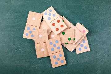 Wooden Domino Tiles Scattered On Green Tabletop Background