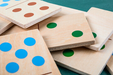 Wooden Domino Tiles With Colored Dots Stacked In Close Up