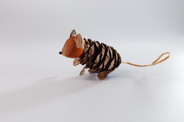 creative mouse character from natural forest materials pine cone nut shell twine. concept for eco packaging sustainable brand identity children book illustration organic food marketing mascot,
