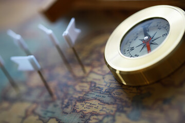 Vintage Compass on Map with Flag Markers Indicating Locations