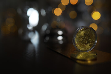 Golden Bitcoin on Reflective Surface with Bokeh Lights in Background