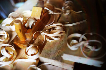 Hand planer with wooden sawdust. On a wooden background. High quality photo