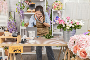 Florist shopkeeper, small business owner arranging fresh flowers while checking tablet orders, creative retail workflow, customer service focus, modern flower shop lifestyle with technology support