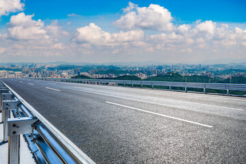 Fototapeta premium Empty asphalt road and city skyline with mountain landscape in Shenzhen