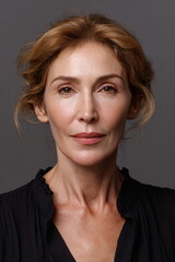 middle aged professional woman portrait neutral background studio lighting realistic skin texture