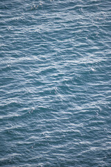 Obraz premium Sparkling Deep Blue Mediterranean Sea Surface with Rippling Waves and Sunlight Reflections