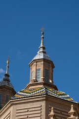 Fototapeta premium Decorative rooftop of a historic building against blue sky.. Cathedral-Basilica of Our Lady of the Pillar, Zaragoza, Spain