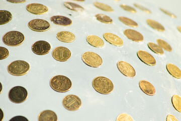 Kazakhstani Tenge Coins Embedded and Frozen in a Clear Sheet of Ice