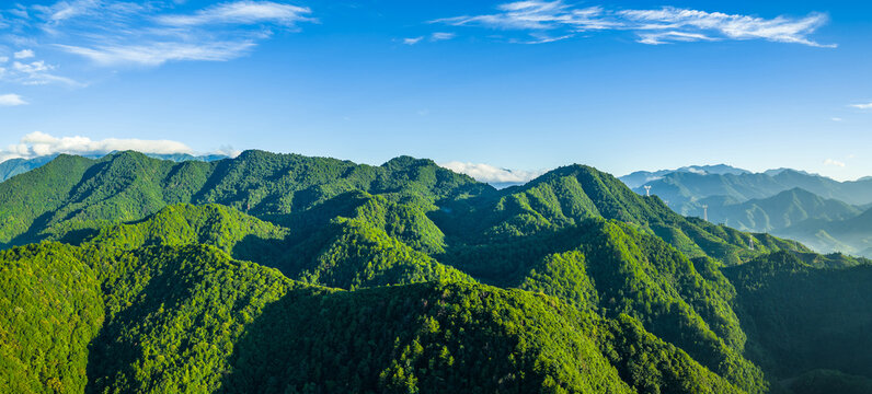 Panoramic view of the green mountain range and forest natural landscape in the morning