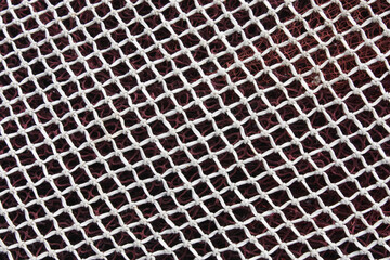 Close-up of White Fishing Net Texture with Knots: Industrial or Maritime Grid Background for Nautical Themes and Design Projects.