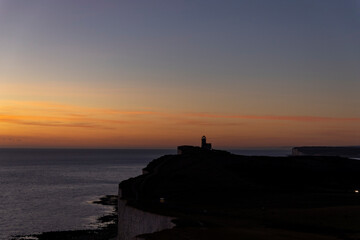 Last rays of sun over Beachy Head, Eastbourne, England with a view towards the old light house