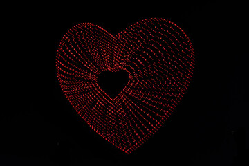 a red drone heart made with various drones
differed drones makes a hart figure in the air