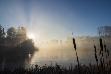 Lake with soft sun beams and fog as grief and loss cocept