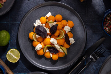 Cantaloupe melon balls salad with feta, lime, and basil