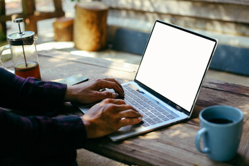 computer screen blank mockup.work using laptop with white background for advertising,contact business search information on desk at coffee shop.marketing and creative design