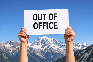 Two raised hands hold a white paper sign with Out of Office text with clear blue sky.