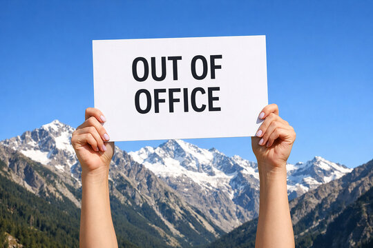 Two raised hands hold a white paper sign with Out of Office text with clear blue sky.