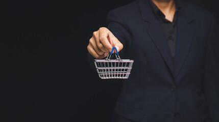 Businessman holding shopping basket for purchase concept.