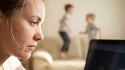 Profile portrait of a woman trying to finish a project amidst the screams of children at home