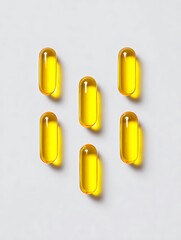 Yellow Softgel Capsules on White Background Vitamins, Supplements and Healthcare Copy Space