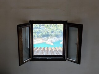 seaside view scene, coastal bay with boats, wooden window overlooking tranquil seaside landscape