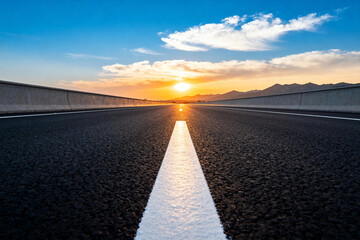 Sunset Highway with Clear Blue Sky and Asphalt Road