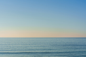 Beautiful summer seascape with clouds and a clear blue sky, background for summer vacation concept.