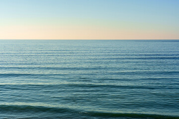 Beautiful summer seascape with clouds and a clear blue sky, background for summer vacation concept.
