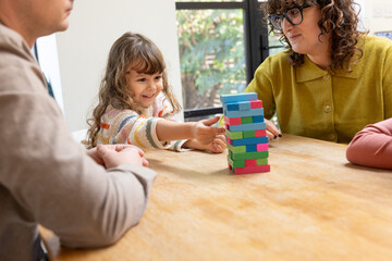 Family Playing a Game Together with Joyful Moments