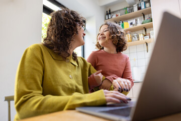 Daughter distracting Mum working from home