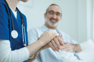 The doctor shaking hands with the elderly man demonstrates care and encouragement for the patient. This image conveys themes of healthcare, trust, empathy, compassion, hope, and kindness.