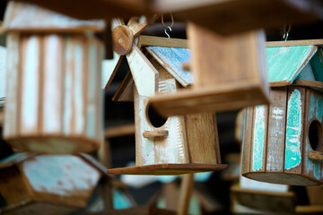 Colorful Wooden Birdhouses Hanging in a Rustic Outdoor Setting