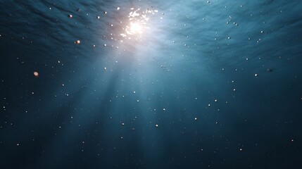 Sunlight streams through clear blue ocean water creating a serene scene with countless shimmering bubbles floating towards the surface