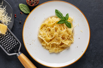 Homemade Fettuccine Alfredo Pasta with cheese in ham plate. Top view