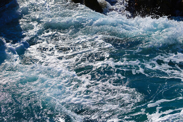 Beach by the sea with foam and spray from the waves