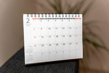 A close-up view of a spiral-bound calendar displaying February 2026. The layout highlights the month's dates and days of the week, suitable for planning and organization.