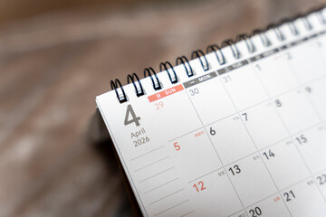 Close-up of a calendar page marked April 4, 2026, showing detailed layout with dates and days. Useful for planning, organization, or time management themes.
