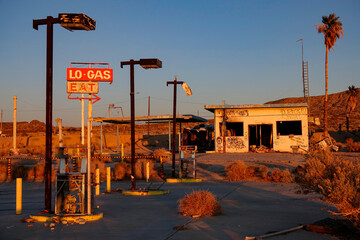 Scenic shot of golden evening sunshine illuminating an abandoned gas pump.