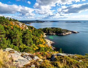 A vibrant coastal scene, showcasing autumn foliage along rocky cliffs, verdant forests, and a tranquil ocean under a partly cloudy sky