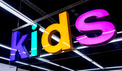 Glowing signboard on a black background at the clothes store