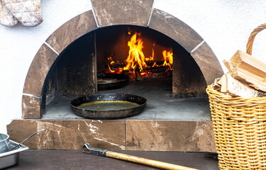 Cooking traditional pies in stove with fire inside