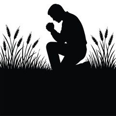 Silhouette of a man praying kneeling in a field of tall grass