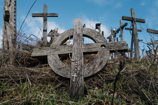 Wooden cross with rosary at the Hill of Crosses in Lithuania