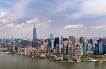 Lower manhattan skyline with one world trade center dominating under cloudy sky