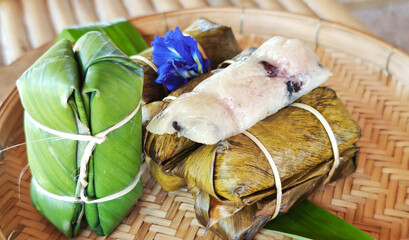 Khao Tom Mud ,Traditional Thai dessert sticky rice, coconut milk and banana wrapped and black beans in banana leaves