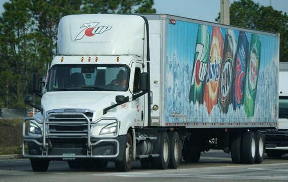 Lakeland, Florida, U.S.A - Jan 2, 2026 - The 7UP semi-truck with soda brand advertisements including Sunkist, AW, RC Cola, and Canada Dry
