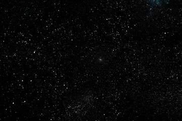 Chaotic white star bokeh on a isolated black background. falling blurry bokeh snow overlay, starry sky. white spots on black background, white drops and spots. abstraction.