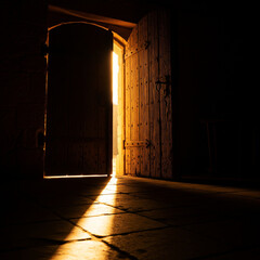 Dramatic Golden Light Shining Through a Slightly Open Door