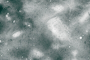 abstract photography of bubbles floating on a liquid surface, creating a textured pattern