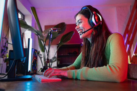 Woman playing a multiplayer video game at home